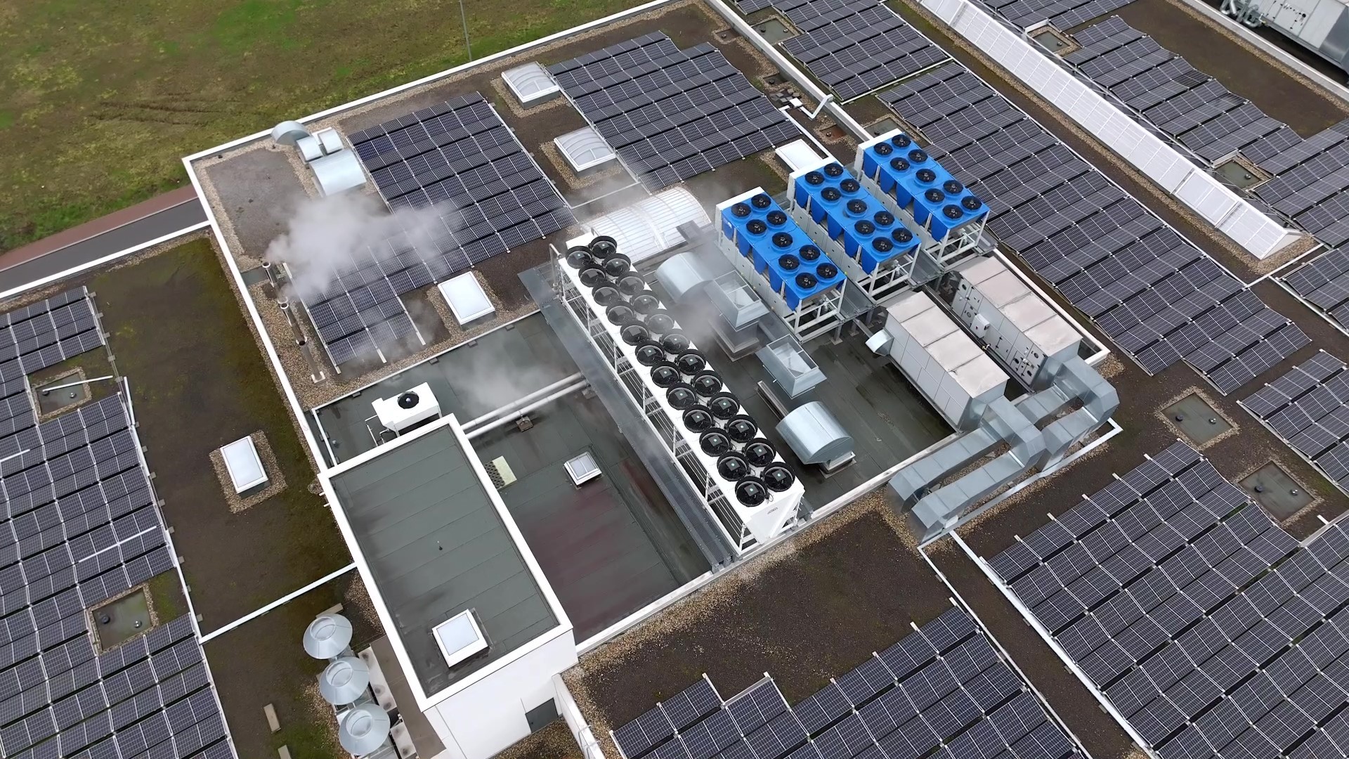 Aerial view of an industrial rooftop featuring  a central HVAC system